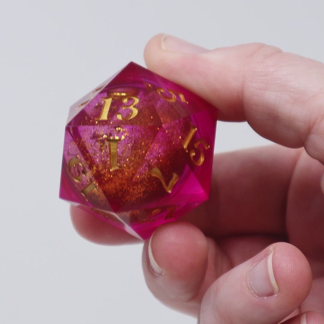 A pink liquid core D20 is rotated to show the viewer the sparkling liquid core.