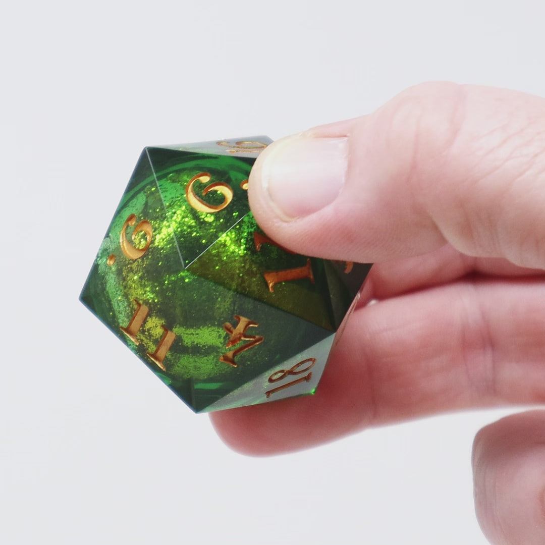 A green liquid core D20 is rotated to show the viewer the sparkling liquid core.